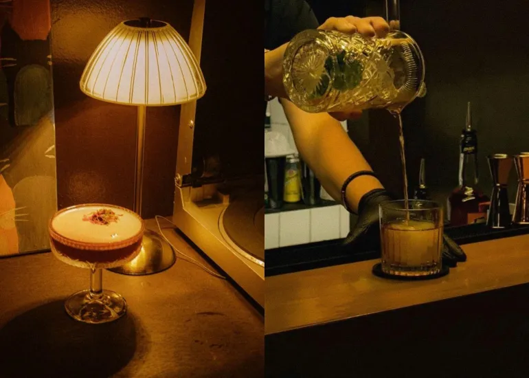 Bartender crafting cocktails at Blue Door 304, with elegant cocktail in a coupe glass by warm lamplight